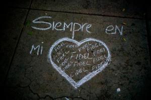 A heart and the text that reads in Spanish "Always in my heart Fidel" are outlined in chalk on a sidewalk, during a vigil at the university where the late Cuban leader Fidel Castro studied law as a young man in Havana, Cuba, Saturday, Nov. 26, 2016. Castro, who led a rebel army to improbable victory in Cuba, embraced Soviet-style communism and defied the power of U.S. presidents during his half century rule, died at age 90. (AP Photo/Ramon Espinosa)