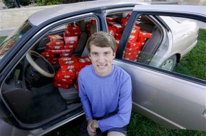 IMAGE DISTRIBUTED FOR THE HERSHEY COMPANY - Hunter Jobbins, freshman at Kansas State University, poses with his car filled with nearly 6,500 Kit Kat bars on Thursday, Nov. 3, 2016, in Manhattan, Kansas. Earlier this week, Jobbins had a Kit Kat bar stolen from his unlocked car and a mysterious note was left from the thief. (Colin E. Braley/AP Images for The Hershey Company)