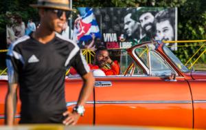 Drivers wait for tourists, in vintage American convertibles at Revolution Square in Havana, Cuba, Sunday, Nov. 27, 2016. Cuba's government declared nine days of national mourning after Cuban leader Fidel Castro died Friday and this normally vibrant city has been notably subdued. As Cuba prepares a massive commemoration for Castro, tens of thousands of high-season travelers have found themselves accidental witnesses to history and in the middle of a somber city that’s little like its usual exuberant self. (AP Photo/Desmond Boylan)
