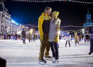 FILE - In this Saturday, Nov. 28, 2015 file photo, Olympic figure skating champion and TV presenter Tatiana Navka, right, and her husband Russian presidential spokesman Dmitry Peskov pose at the opening of a skating rink in Red Square in Moscow. Former Olympic ice dancer Navka and her on-ice partner Andrei Burkovsky caused controversy by dressing up in concentration camp uniforms for a dance routine on a popular television show broadcasted on Saturday, Nov. 26, 2016. (AP Photo/Pavel Golovkin, File)