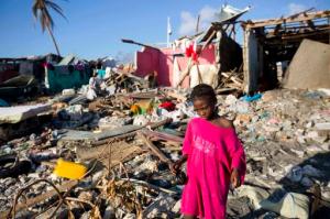 FILE - This is a Wednesday, Oct. 12, 2016. file photo of a girl as she walks through debris where homes once stood after Hurricane Matthew hit Jeremie, Haiti. Hot and wild and with an “increasingly visible human footprint” _ that’s how the U.N. weather agency summed up the global climate in the past five years. In a report released Tuesday Nov. 8, 2016 at international climate talks in Morocco, the World Meteorological Organization said 2011-2015 was the hottest five-year period on record. (AP Photo/Dieu Nalio Chery, File)