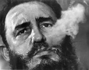 FILE - In this March 1985 file photo, Cuba's leader Fidel Castro exhales cigar smoke during an interview at the presidential palace in Havana, Cuba. Castro has died at age 90. President Raul Castro said on state television that his older brother died late Friday, Nov. 25, 2016. (AP Photo/Charles Tasnadi, File)