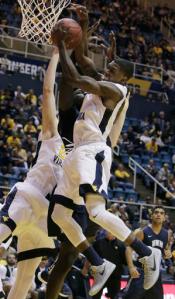 West Virginia guard Teyvon Myers (0) grabs a rebound during the first half of an NCAA college basketball game against New Hampshire, Sunday, Nov. 20, 2016, in Morgantown, W.Va. (AP Photo/Raymond Thompson)