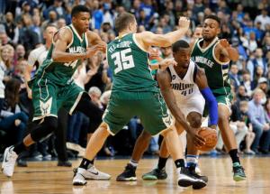 Dallas Mavericks forward Harrison Barnes (40) maneuvers to get out of coverage by Milwaukee Bucks' Giannis Antetokounmpo (34) of Greece, Mirza Teletovic (35) of Bosnia and Herzegovina and Jabari Parker, right rear, in overtime of an NBA basketball game, Sunday, Nov. 6, 2016, in Dallas. (AP Photo/Tony Gutierrez)