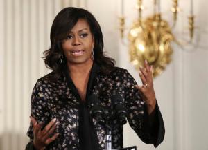 In this Friday, Oct. 21, 2016, file photo, first lady Michelle Obama speaks to student participants during a Grammy Museum musical workshops hosted by the first lady in the East Room of the White House in Washington.  Clay Town, W.Va. Mayor Beverly Whaling resigned her post Tuesday, Nov. 15, following a backlash after she posted a response to a racist comment about the first lady on Facebook. (AP Photo/Manuel Balce Ceneta, File)