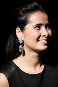 FILE- in this Thursday, Nov. 10, 2016 file photo, a model displays a pair of stunning diamond earrings "Miroir de l'Amour" weighing 52.55 and 50.47 carats during a Christie's press preview in Geneva, Switzerland. A pair of pear-shaped diamond earrings has sold at a Christie's auction for 17.57 million Swiss francs ($17.6 million), well short of the pre-sale estimate of 20 million to 30 million Swiss francs. The 250-year-old auction house touted the "Miroir de l'Amour" (Mirror of Love) earrings as the largest D Flawless, or highest-quality, pear-shaped diamonds in the world, at more than 50 carats each.( Jean-Christophe Bott/Keystone via AP, file)