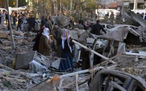 People watch the damage after an explosion in southeastern Turkish city of Diyarbakir, early Friday, Nov. 4, 2016. A large explosion hit the largest city in Turkey's mainly Kurdish southeast region on Friday, wounding several people, the state-run Anadolu Agency reported. The cause of the explosion was not immediately known but Hurriyet newspaper said it may have been caused by a car bomb. (IHA via AP)