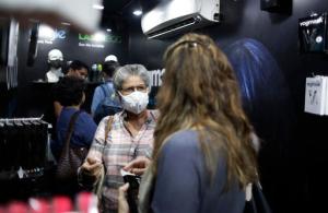 An Indian woman talks to another wearing a face mask against air pollution at a shop in New Delhi, India, Friday, Nov. 4, 2016. A new report from UNICEF says about a third of the 2 billion children in the world who are breathing toxic air live in northern India and neighboring countries, risking serious health effects including damage to their lungs, brains and other organs. New Delhi's air pollution is among the world's worst, spikes every winter because of the season's weak winds and countless garbage fires. (AP Photo/Altaf Qadri)