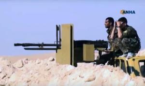 This frame grab from video provided on Monday, Nov. 7, 2016, by the Hawar News Agency, shows U.S.-backed fighters take position during fighting with the Islamic State group in the village of Laqtah, north of Raqqa, Syria. Turkey said Tuesday that Washington has promised that U.S.-backed Syrian Kurdish forces will only be involved in encircling the Islamic State stronghold of Raqqa and will not enter the city itself. (Hawar News Agency, via AP)