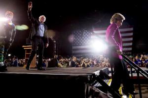 Democratic presidential candidate Hillary Clinton, right, accompanied by Sen. Bernie Sanders, D-Vt., second from left, and performer Pharrell Williams, left, steps off the stage after speaking at a rally at Coastal Credit Union Music Park at Walnut Creek in Raleigh, N.C., Thursday, Nov. 3, 2016. (AP Photo/Andrew Harnik)