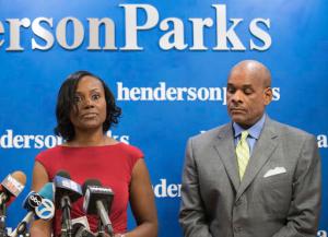 In this Sept. 22, 2016 photo, attorney Rhonda Crawford stands alongside her attorney Victor Henderson, as she addresses allegations that she impersonated a judge. Crowford, a judicial candidate, now faces charges for donning a robe and hearing real cases on the bench. The Cook County State's Attorney's Office said Friday Oct. 21, 2016 in a statement that Crawford has been indicted on charges of felony official misconduct and misdemeanor false impersonation. (Max Herman/Chicago Sun-Times via AP)