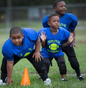 ADVANCE FOR SUNDAY DEC. 18 AND THEREAFTER - In a Sept. 29, 2016 photo, from left: Kemari Coleman, Tobias Armstrong and Korey Brown during warmup drills at a practice of the super tiny mites team of the 757 Seahawks Youth Athletic Association in Sept. 2016 in Chesapeake, Va., as they prepare for their next game. (Bill Tiernan/The Virginian-Pilot via AP)