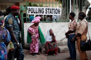 Gambians wait to cast their vote at a polling station in Banjul, Gambia, Thursday Dec. 1, 2016. Voters in the tiny West African nation of Gambia cast marbles Thursday in an election widely expected to keep the country's ruler of more than two decades in power despite a unified effort by the opposition. (AP Photo/Jerome Delay)