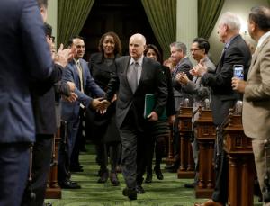 Calif., Gov. Jerry Brown is greeted by lawmakers as he enters the Assembly to deliver his annual State of the State address to a joint session of the state Legislature Tuesday, Jan. 24, 2017, in Sacramento, Calif. (AP Photo/Rich Pedroncelli)