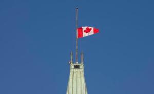 The flag flies at half-mast on the Peace tower Monday Jan. 30, 2017 in Ottawa. It was announced Monday that the flag would fly at half-mast in memory of the victims of the Quebec City shooting.(Adrian Wyld/The Canadian Press via AP)