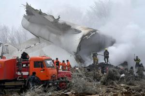 Kyrgyz Emergency Ministry officials work among remains of a crashed Turkish Boeing 747 cargo plane at a residential area outside Bishkek, Kyrgyzstan Monday, Jan. 16, 2017. The cargo plane crashed Monday morning, killing people in the residential area adjacent to the Manas airport as well as those on the plane. (AP Photo/Vladimir Voronin)