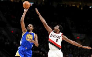 Golden State Warriors forward Kevin Durant puts up a shot on Portland Trail Blazers forward Al-Farouq Aminu during the first half of an NBA basketball game in Portland, Ore., Sunday, Jan. 29, 2017. (AP Photo/Steve Dykes)
