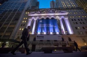 FILE - In this Tuesday, Oct. 25, 2016, file photo, a pedestrian walks past the New York Stock Exchange, in lower Manhattan. Global stock markets fell Monday, Jan. 30, 2017, after President Donald Trump's decision to impose a travel ban on seven Muslim-majority countries. Airlines and technology companies took some of the largest losses. Rite Aid is falling after Walgreens lowered the price it will pay to buy the company. (AP Photo/Mary Altaffer, File)