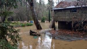 Flooded properties are seen in Paradise Park in Santa Cruz County, Calif., Sunday morning, Jan. 22, 2017. Fast-moving floodwaters swept through mountain communities and residents fled homes below hillsides scarred by wildfires as the third and largest in the latest series of storms brought powerful rain Sunday and warnings about damaging mudslides. (Ryan Masters/The Santa Cruz Sentinel via AP)