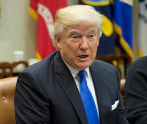 FILE - In this Tuesday, Jan. 24, 2017, file photo, President Donald Trump speaks during his meeting with automobile leaders in the Roosevelt Room of the White House in Washington. In a tweet Tuesday night President Donald Trump served notice he's ready to "send in the Feds" if Chicago can't reduce its homicide figures. (AP Photo/Pablo Martinez Monsivais, File)
