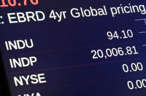 A board above the trading floor of the New York Stock Exchange shows the Dow Jones industrial average at the opening bell, Wednesday, Jan. 25, 2017. The DJIA is trading over 20,000 points for the first time, the latest milestone in a record-setting drive for the stock market. The market has been marching steadily higher since bottoming out in March 2009 in the aftermath of the financial crisis. (AP Photo/Richard Drew)