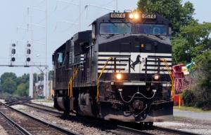 FILE - In this June 4, 2014, file photo, a Norfolk Southern locomotive moves along the tracks in Norfolk, Va. Norfolk Southern Corp. (NSC) on Wednesday, Jan. 25, 2017, reported fourth-quarter net income of $416 million. (AP Photo/Steve Helber, File)