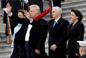 President Donald Trump and first lady Melania Trump along with Vice President Mike Pence and his wife Karen wave to former President Barack Obama during a departure ceremony on the East Front of the U.S. Capitol in Washington, Friday, Jan. 20, 2017, after Trump was inaugurated. (AP Photo/Evan Vucci)