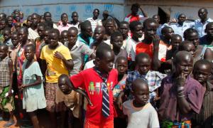 FILE - In this Monday, Aug. 29, 2016 file photo, refugees wait for U.N. High Commissioner for Refugees Filippo Grandi to arrive at a transit center for South Sudanese refugees in the remote northwestern district of Adjumani, near the border with South Sudan, in Uganda. More than 1.5 million South Sudanese have become refugees and their humanitarian needs are overwhelming aid efforts during the country's civil war, according to the United Nations. (AP Photo/Stephen Wandera, File)