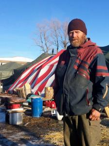 In this Thursday, Feb. 16, 2017, photo, Bryce Peppard, from Oregon, poses for a photo in the Dakota Access oil pipeline protest camp in southern North Dakota near Cannon Ball. Authorities have told people remaining in the camp to leave by Wednesday, Feb. 22, in advance of spring flooding. Some in the camp, including Peppard, say they will resist any efforts to force them to leave. (AP Photo/Blake Nicholson)