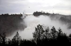 Water gushes down the Oroville Dam's main spillway Wednesday, Feb. 15, 2017, in Oroville, Calif. The Oroville Reservoir is continuing to drain Wednesday as state water officials scrambled to reduce the lake's level ahead of impending storms. (Chris Kaufman/The Appeal-Democrat via AP)