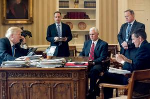 FILE - In this Jan. 28, 2017 file photo, President Donald Trump accompanied by, from second from left, Chief of Staff Reince Priebus, Vice President Mike Pence, White House press secretary Sean Spicer and then-National Security Adviser Michael Flynn speaks on the phone with Russian President Vladimir Putin, in the Oval Office at the White House in Washington. Trump's White House is nearly paralyzed by crisis, divisions and dysfunction. Virtually all policy announcements have slowed to a crawl. Aides are undercutting each other in leaks (AP Photo/Andrew Harnik, File)