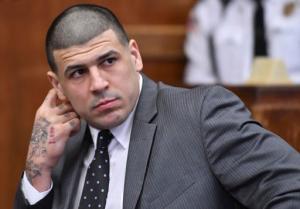 FILE- In this Dec. 27, 2016, file photo, former New England Patriots player Aaron Hernandez appears in Suffolk Superior Court for a pretrial hearing before Judge Jeffrey Locke in Boston. Hernandez, who is serving a life sentence for a 2013 murder, is scheduled to go on trial in Feb 13, 2017, for the murder of two men in a 2012 drive-by shooting. Body art has played a role in a surprising number of criminal cases nationwide, though legal experts concede that tattoos by themselves are rarely a deciding factor in convictions. (Josh Reynolds/The Boston Globe via AP, Pool, File)