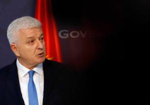 In this Friday, Feb. 3, 2017 photo, Montenegro's Prime Minister Dusko Markovic speaks during a press conference after talks with his Serbian counterpart Aleksandar Vucic at the Serbia Palace in Belgrade, Serbia. Markovic said Tuesday, Feb. 14, 2017 that those who want to destabilize the country by meddling into its affairs "should keep their hands off Montenegro." (AP Photo/Darko Vojinovic)