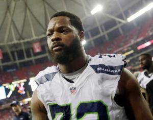 FILE - In this Jan. 14, 2017, file photo, Seattle Seahawks defensive end Michael Bennett (72) walks off the field after an NFL football divisional football game against the Atlanta Falcons, in Atlanta. In an embarrassment to the Israeli government, only five of 11 NFL players have arrived on a sponsored trip aimed at improving the country's image. The ministry for strategic affairs and public diplomacy issued a press release after the Super Bowl boasting that the visit would bring "influencers" who would serve as "goodwill ambassadors" when they returned home. The announcement led Seahawks Michael Bennett to pull out. He accused the government of trying to use him for PR purposes and cited sympathy for the Palestinians. Several others players followed suit. (AP Photo/David Goldman, File)
