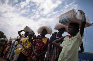 In this photo taken Wednesday, Oct. 19, 2016 and released by UNICEF, a young girl who fled fighting in nearby Leer in recent months, queues for food aid at a food distribution made by the World Food Programme in Bentiu, South Sudan. Famine has been declared Monday, Feb. 20, 2017 in two counties of South Sudan, according to an announcement by the South Sudan government and three U.N. agencies, which says the calamity is the result of prolonged civil war and an entrenched economic crisis that has devastated the war-torn East African nation. (Kate Holt/UNICEF via AP)
