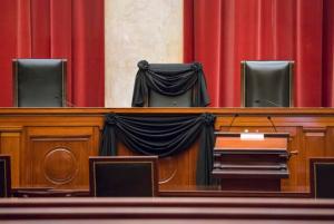 FILE - In this Feb. 16, 2016 file photo, Supreme Court Justice Antonin Scalia's courtroom chair is draped in black to mark his death as part of a tradition that dates to the 19th century, at the Supreme Court in Washington. In the year since Scalia’s death last February, the court’s empty place has often been referred to as “Justice Scalia’s seat.” But as Supreme Court Justice nominee Neil Gorsuch suggested, the seat’s history actually goes back more than 150 years. The lineage includes seven men, all but one nominated to the seat by Republican presidents.  (AP Photo/J. Scott Applewhite, File)
