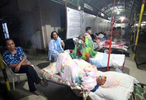 Patients spend the night outside a hospital after abandoning their rooms following a powerful earthquake that rocked Surigao city, Surigao del Norte province, in the southern Philippines, Saturday, Feb.11, 2017. Officials said, the powerful earthquake with a magnitude of 6.5, caused an undetermined number of casualties, damaged roads and buildings, including the airport, and knocked power out. (AP Photo)