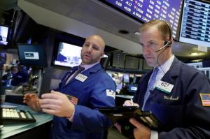 Specialist John Parisi, left, and trader Michael Smyth work on the floor of the New York Stock Exchange, Friday, Feb. 17, 2017. Stocks are posting moderate declines in early trading as a fast-paced market rally of the past two weeks goes into reverse. (AP Photo/Richard Drew)