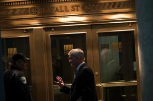 FILE - In this Tuesday, Oct. 25, 2016, file photo, a trader speaks to a security guard as he leaves the New York Stock Exchange, in lower Manhattan. European shares rose solidly Tuesday, Feb. 7, 2017, after a leading American investment firm recommended clients to buy the region's stocks. (AP Photo/Mary Altaffer, File)