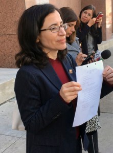 Dallas immigration attorney Fatma Marouf holds up a bond order in front of the federal building after leaving immigration court in Dallas, Thursday, March 2, 2017, from a federal immigration judge for Sara Beltran Hernandez, a Salvadoran woman seeking asylum. An immigration judge has granted bond to Hernandez so she can leave a detention facility to seek treatment for a brain tumor. (AP Photo/Claudia Lauer)