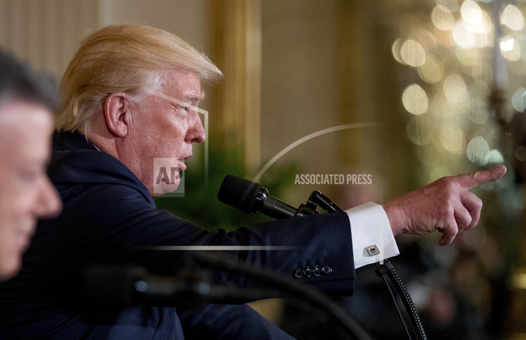 Trump, dogged by questions at home, makes first trip&nbsp;abroad